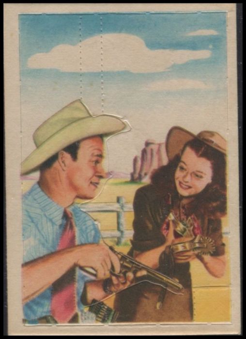 F278-19 32 Dale Helps Roy With Guns And Spurs.jpg